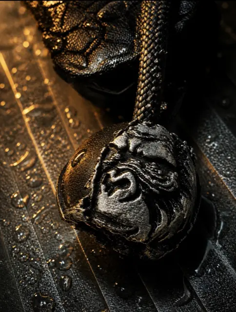 Bronze sasquatch bead covered in water droplets