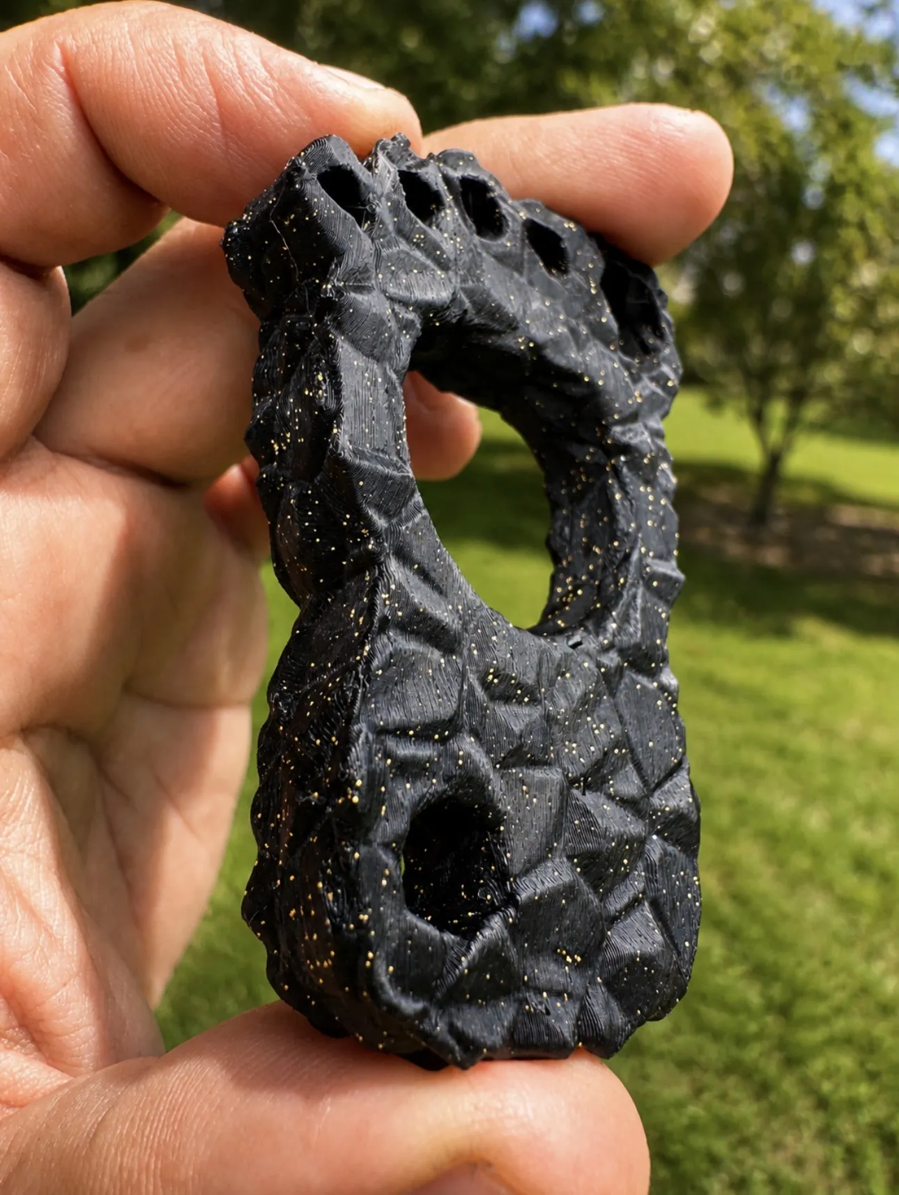 Resin knucks hanging in a row outdoors